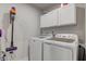 Well-organized laundry room with washer, dryer, and overhead cabinets at 2747 Stonebridge Dr, Lebanon, IN 46052