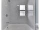 This bright bathroom features a shower and tub combination with tiled walls and a window above the tub at 2945 N Denny St, Indianapolis, IN 46218