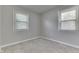 A carpeted bedroom with two windows providing natural light and neutral paint at 2945 N Denny St, Indianapolis, IN 46218