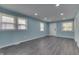 Bright living room with new gray flooring, recessed lighting, fresh paint, and abundant natural light at 2945 N Denny St, Indianapolis, IN 46218