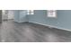 Open-concept living room featuring new gray flooring, fresh paint, and an abundance of natural light at 2945 N Denny St, Indianapolis, IN 46218