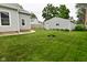 Spacious backyard with a detached garage and well-maintained lawn, perfect for outdoor activities at 305 N Warman Ave, Indianapolis, IN 46222