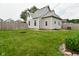 Spacious backyard with a well-maintained lawn and privacy fence, perfect for outdoor enjoyment at 305 N Warman Ave, Indianapolis, IN 46222