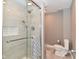 Modern bathroom with a tiled walk-in shower, glass door, and a sleek toilet at 305 N Warman Ave, Indianapolis, IN 46222