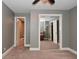 Bedroom with neutral walls, carpet, and mirrored closet doors reflecting another room at 305 N Warman Ave, Indianapolis, IN 46222