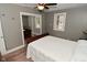 Comfortable bedroom with ceiling fan and a closet with sliding mirror doors at 305 N Warman Ave, Indianapolis, IN 46222
