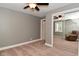 Bedroom featuring carpet, neutral walls, mirrored closet doors, and a ceiling fan at 305 N Warman Ave, Indianapolis, IN 46222