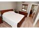 Spacious bedroom with a classic wooden bed frame, dresser, and soft carpeting at 305 N Warman Ave, Indianapolis, IN 46222