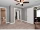 Bedroom with neutral carpet and walls, with mirrored closet doors and two entryways at 305 N Warman Ave, Indianapolis, IN 46222