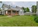 Charming two-story home with inviting front porch and lush green lawn at 305 N Warman Ave, Indianapolis, IN 46222