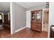 Bright hallway with a stylish display cabinet and an adjacent doorway to a bathroom at 305 N Warman Ave, Indianapolis, IN 46222