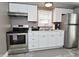 Modern kitchen with stainless steel appliances and white cabinets at 305 N Warman Ave, Indianapolis, IN 46222