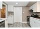 Bright kitchen featuring white cabinets, stainless steel appliances, and ample counter space at 305 N Warman Ave, Indianapolis, IN 46222