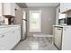 Well-lit kitchen with white cabinets and stainless steel appliances at 305 N Warman Ave, Indianapolis, IN 46222