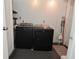 Laundry room area with a new black Maytag washer and dryer set at 305 N Warman Ave, Indianapolis, IN 46222