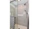 Contemporary walk-in shower featuring gray tile and a convenient built-in shower caddy at 305 N Warman Ave, Indianapolis, IN 46222