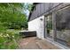 Brick home with wood patio, modern furniture, and sliding glass doors at 3141 Citadel Ct, Indianapolis, IN 46268