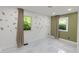 Bright bedroom featuring stylish tile floors, leafy art decals, and sunlit windows with tan colored curtains at 3141 Citadel Ct, Indianapolis, IN 46268
