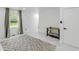 Bright bedroom featuring stylish tile floors, sunlit window and a playpen at 3141 Citadel Ct, Indianapolis, IN 46268
