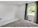 An airy bedroom featuring tile floors and a sunlit window with decorative curtains at 3141 Citadel Ct, Indianapolis, IN 46268