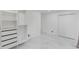 A minimalist bedroom featuring modern tile floors, closet and an adjacent door at 3141 Citadel Ct, Indianapolis, IN 46268