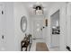 Modern foyer featuring white marble floors, contemporary lighting, and a decorative console table, leading to the living spaces at 3141 Citadel Ct, Indianapolis, IN 46268