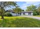 Charming single-story home featuring a white brick exterior, black shutters, an attached garage, and a well-maintained front yard at 3141 Citadel Ct, Indianapolis, IN 46268