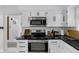 Well-appointed kitchen features stainless steel appliances, white cabinets, subway tile backsplash, and granite countertops at 3141 Citadel Ct, Indianapolis, IN 46268