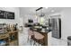 Stylish kitchen features an island with bar seating, modern appliances, and opens to the living area at 3141 Citadel Ct, Indianapolis, IN 46268