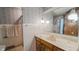 A bathroom with wallpaper, tile walls, a sink vanity, and a toilet at 3215 E 10Th St, Anderson, IN 46012