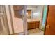 Bathroom featuring tiled shower, wallpaper, and vanity with sink at 3215 E 10Th St, Anderson, IN 46012