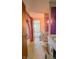 Bathroom with a tub/shower combo featuring a pink curtain and adjacent toilet and sinks with purple accents and vintage wallpaper at 3215 E 10Th St, Anderson, IN 46012
