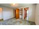 A bedroom with an adjacent view of a bathroom and closet with exposed shelving at 3215 E 10Th St, Anderson, IN 46012
