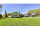 Single-story home with a well-kept lawn in a residential neighborhood with mature trees at 3215 E 10Th St, Anderson, IN 46012