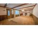 Living room with brick fireplace, wood trim, stained ceiling beams, and carpeted floor at 3215 E 10Th St, Anderson, IN 46012