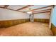 A living room featuring wood trim, stained ceiling beams, a window and carpeted floor at 3215 E 10Th St, Anderson, IN 46012