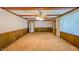 A living room featuring wood trim, stained ceiling beams, a window and carpeted floor at 3215 E 10Th St, Anderson, IN 46012