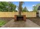 Outdoor brick fireplace in a large backyard with grass at 3453 W 12Th St, Indianapolis, IN 46222