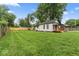 Large, fully fenced backyard featuring a spacious lawn perfect for outdoor enjoyment at 3453 W 12Th St, Indianapolis, IN 46222