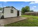 Rear exterior view of house with fenced yard, back door, and concrete patio at 3453 W 12Th St, Indianapolis, IN 46222