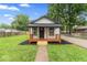 Charming single-story home featuring a cozy front porch and well-manicured lawn at 3453 W 12Th St, Indianapolis, IN 46222