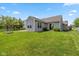 Spacious backyard featuring a well-maintained lawn, fenced garden area, and a home's facade at 3779 Crest Point Dr, Westfield, IN 46062