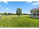 Expansive backyard featuring a lush lawn, mature tree, and pond with a fountain, creating a serene outdoor oasis at 3779 Crest Point Dr, Westfield, IN 46062