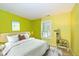 Vibrant bedroom featuring colorful walls, natural light, a bed, and playful decor at 3779 Crest Point Dr, Westfield, IN 46062