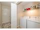 Functional laundry room with a washer, dryer, and shelving for storage at 3779 Crest Point Dr, Westfield, IN 46062
