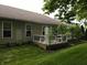 This backyard features a well-kept lawn and a raised deck with plantings at 4232 Parliament Way, Avon, IN 46123