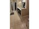 A bathroom includes a large vanity with double sinks, a walk-in closet, and neutral-colored tiling at 4232 Parliament Way, Avon, IN 46123