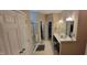 A bathroom features a shower with glass doors, a double sink vanity, and a walk-in closet at 4232 Parliament Way, Avon, IN 46123