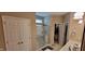 A bathroom includes a stand-up shower with glass doors, a linen closet, and neutral-colored walls at 4232 Parliament Way, Avon, IN 46123