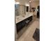 A bathroom features a double sink vanity with dark cabinetry and a walk-in closet in the background at 4232 Parliament Way, Avon, IN 46123